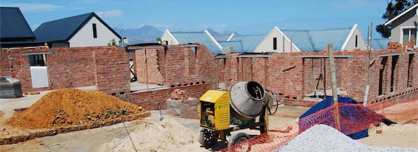 Home Building in progress next to a few already completed houses